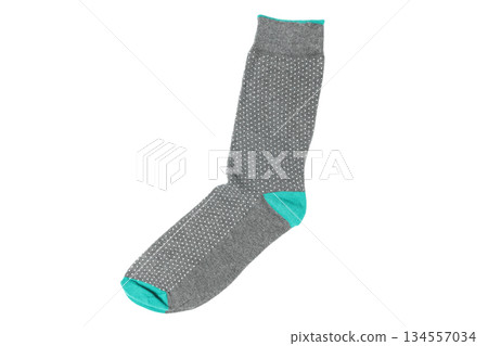 One sock with different lines isolated on white background. Colorful sock son white background. Colored socks on the leg isolated on white background 134557034