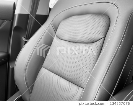 Black luxury modern car Interior. Detail of modern car interior. Part of black leather seats with red stitching in expensive car Black luxury modern car Interior. Detail of modern car interior. Part of black leather seats with red stitching in expensive car 134557076