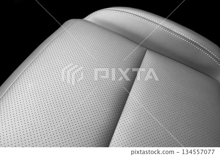 Modern luxury car black leather interior. Part of black leather car seat details with white stitching. Interior of prestige car. Perforated leather seats isolated. Perforated leather. Modern luxury car black leather interior. Part of black leather car seat details with white stitching. Interior of prestige car. Perforated leather seats isolated. Perforated leather. 134557077