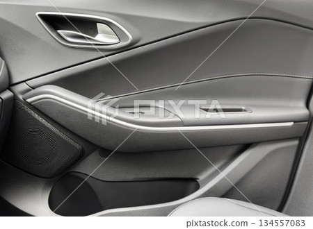 Door handle with Power window control buttons of a luxury passenger car. Black leather interior of the luxury modern car. Modern car interior details 134557083