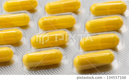 Macro shot pile of tablets pill in silver blister packaging isolated on white background. Aluminium foil blister pack. Pharmacy products. Medicine pills and drugs close up. Pills background Macro shot pile of tablets pill in silver blister packaging isolated on white background. Aluminium foil blister pack. Pharmacy products. Medicine pills and drugs close up. Pills background 134557108