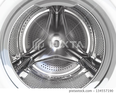 Washing machine drum close up. Washing machine background. Inside the washing machine. Metal washing machine drum. Perforated shiny metal Washing machine drum close up. Washing machine background. Inside the washing machine. Metal washing machine drum. Perforated shiny metal 134557190