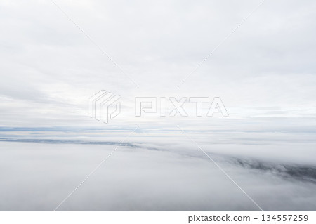 Aerial view White clouds in blue sky. Top. View from drone. Aerial bird's eye. Aerial top view cloudscape. Texture of clouds. View from above. Sunrise or sunset over clouds 134557259