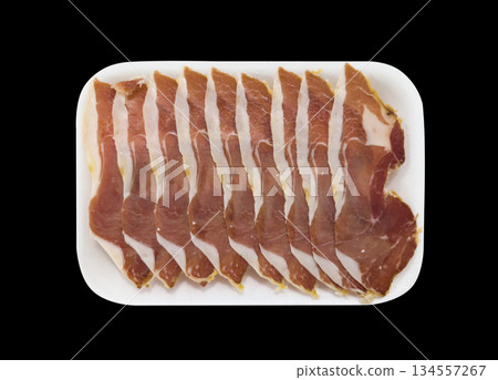 Jamon serrano. A Spanish ham isolated on black background. Traditional spanish jamon sliced. Dry cured meat ham. Hamon iberico Jamon serrano. A Spanish ham isolated on black background. Traditional spanish jamon sliced. Dry cured meat ham. Hamon iberico 134557267