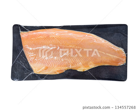 Vacuum packaged salmon fish isolated on white background. Vacuum packaged salmon fish isolated on white background. 134557268
