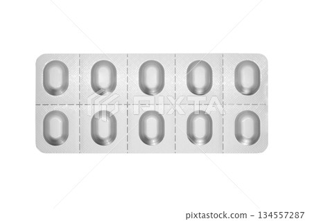 Macro shot pile of tablets pill in silver blister packaging isolated on white background. Aluminium foil blister pack. Pharmacy products. Medicine pills and drugs close up. Pills background 134557287