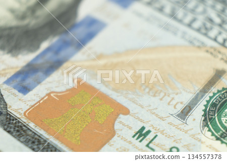 Macro shot image of the corner of a 100 dollar bill banknotes. Concept of financial success. Background of 100 dollar bills. One hundred dollars. 134557378