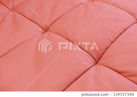 Red leather texture. Part of perforated leather details. Red perforated leather texture background. Texture, artificial leather with diagonal stitching. Red leather texture. Part of perforated leather details. Red perforated leather texture background. Texture, artificial leather with diagonal stitching. 134557399