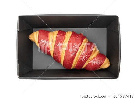 Fresh baked croissant in paper box isolated on white background. Delicious french croissant isolated. 134557415