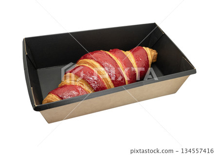 Fresh baked croissant in paper box isolated on white background. Delicious french croissant isolated. Fresh baked croissant in paper box isolated on white background. Delicious french croissant isolated. 134557416