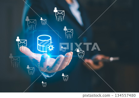 A business professional presenting glowing database icon with email user symbols, illustrating data processing, digital communication, cloud technology and efficient information management solutions. A business professional presenting glowing database icon with email user symbols, illustrating data processing, digital communication, cloud technology and efficient information management solutions. 134557480