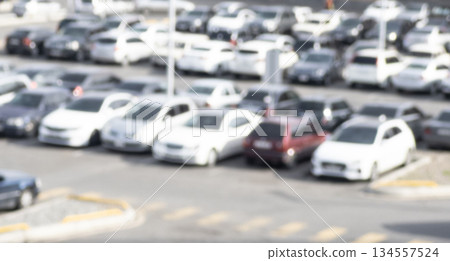 Aerial view blurred cars in car parking lot in shopping mall. Bokeh lights background. Abstract blur car parking lot for background. Blurred cars parking Aerial view blurred cars in car parking lot in shopping mall. Bokeh lights background. Abstract blur car parking lot for background. Blurred cars parking 134557524