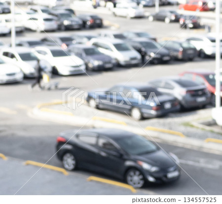 Aerial view blurred cars in car parking lot in shopping mall. Bokeh lights background. Abstract blur car parking lot for background. Blurred cars parking Aerial view blurred cars in car parking lot in shopping mall. Bokeh lights background. Abstract blur car parking lot for background. Blurred cars parking 134557525