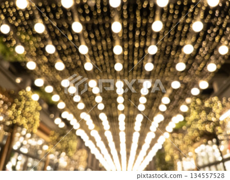 Blurred background. Night city. Blurred silhouette of buildings, bokeh spots of glowing lanterns. Blurred view of city street.Bokeh effect. Defocused night street lights Blurred background. Night city. Blurred silhouette of buildings, bokeh spots of glowing lanterns. Blurred view of city street.Bokeh effect. Defocused night street lights 134557528