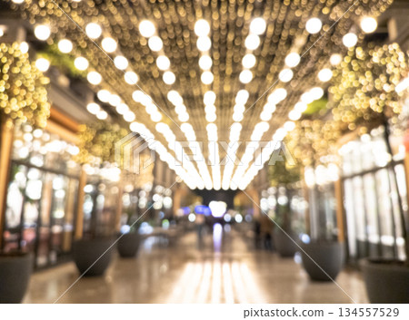 Blurred background. Night city. Blurred silhouette of buildings, bokeh spots of glowing lanterns. Blurred view of city street.Bokeh effect. Defocused night street lights Blurred background. Night city. Blurred silhouette of buildings, bokeh spots of glowing lanterns. Blurred view of city street.Bokeh effect. Defocused night street lights 134557529