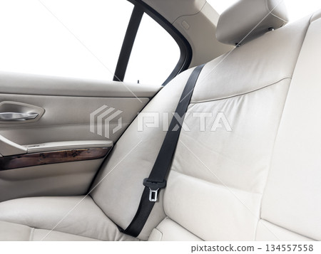 Back passenger white leather seats in modern luxury car. White perforated leather with stitching. Car inside. Leather comfortable red seats. Car interior details Back passenger white leather seats in modern luxury car. White perforated leather with stitching. Car inside. Leather comfortable red seats. Car interior details 134557558