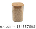 Rice in a glass jar isolated on a white background. Raw white organic rice grains in glass storage jar isolated. 134557608