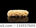 Texture of dry instant noodles isolated on black background. Raw dried Instant ramen noodles block isolated. 134557609