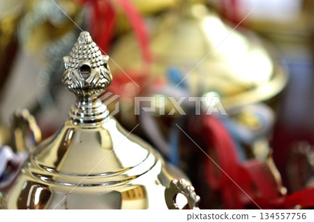 Ornate Golden Trophy Lids with Ribbons 134557756