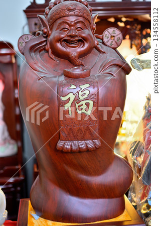 Buddhist deity in the historic Buddhist Jingan Temple on the West Nanjing Road in downtown Shanghai, China 134558112