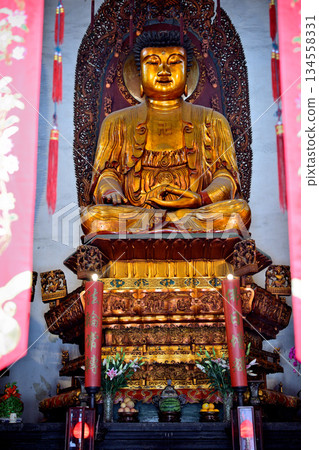 Buddha in the historic Buddhist Jingan Temple on the West Nanjing Road in downtown Shanghai, China Buddha in the historic Buddhist Jingan Temple on the West Nanjing Road in downtown Shanghai, China 134558331