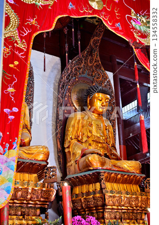 Buddhist deities in the historic Buddhist Jingan Temple on the West Nanjing Road in downtown Shanghai, China 134558332