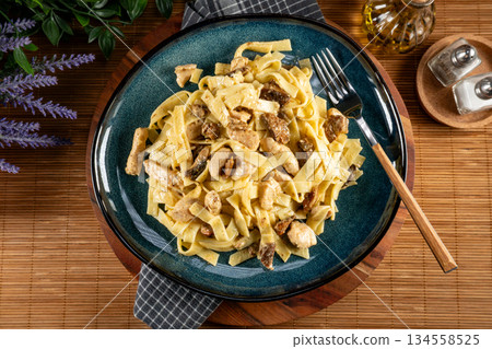 Pasta with pieces of chicken and saffron milk caps. Pasta with pieces of chicken and saffron milk caps. 134558525