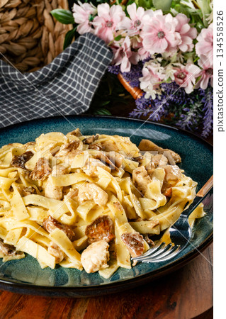 Pasta with pieces of chicken and saffron milk caps. Pasta with pieces of chicken and saffron milk caps. 134558526