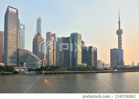 Cityscape sunset view across Huangpu River of Oriental Pearl Tower and Pudong new area in Shanghai, China 134558862