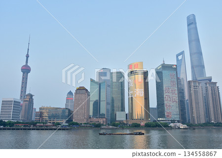 Cityscape view across Huangpu River of Oriental Pearl Tower and Pudong new area in Shanghai, China Cityscape view across Huangpu River of Oriental Pearl Tower and Pudong new area in Shanghai, China 134558867