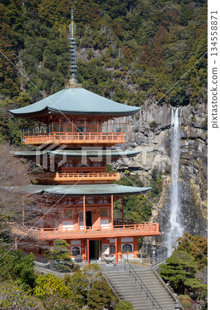 Three story pagoda of Seiganto-ji Tendai Buddhist temple in Wakayama Prefecture, Japan with Nachi Falls in the background 134558871