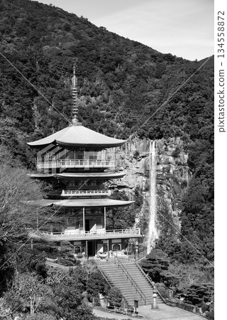 Three story pagoda of Seiganto-ji Tendai Buddhist temple in Wakayama Prefecture, Japan with Nachi Falls in the background 134558872