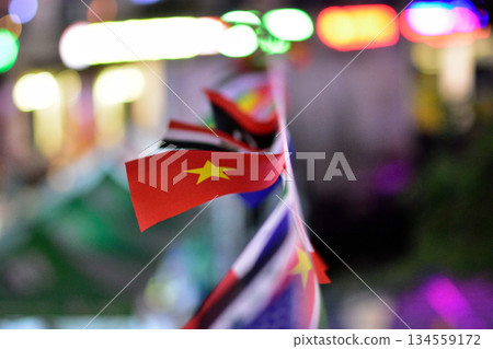 Colorful flags with a focus on a Vietnam flag, blurred background. 134559172