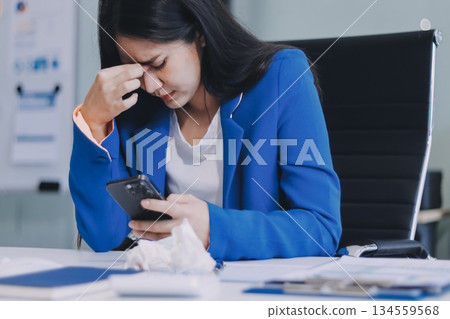 Business woman having headache at office 134559568