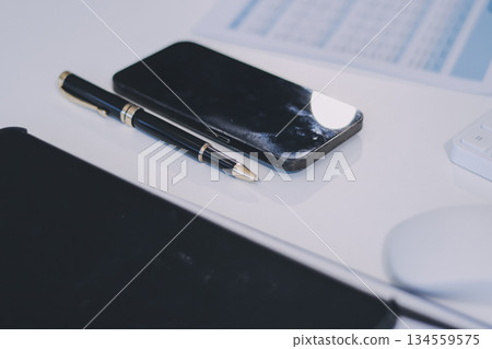 Wooden work desk with laptop and documents, books, modern interior of cozy cabinet, table for businessman or student at home, comfortable workspace, workplace with computer in apartment 134559575