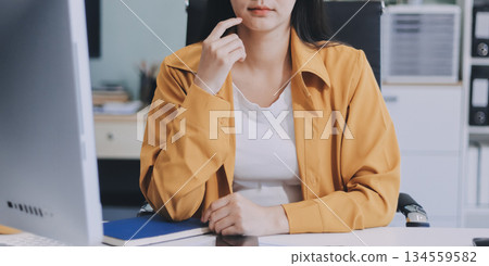 Business woman using calculator for do math finance on wooden desk in office and business working background, tax, accounting, statistics and analytic research concept. Business woman using calculator for do math finance on wooden desk in office and business working background, tax, accounting, statistics and analytic research concept. 134559582