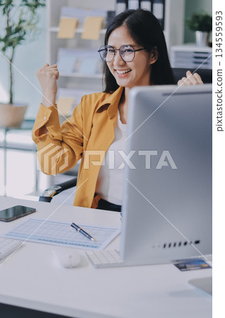 Business woman using calculator for do math finance on wooden desk in office and business working background, tax, accounting, statistics and analytic research concept. Business woman using calculator for do math finance on wooden desk in office and business working background, tax, accounting, statistics and analytic research concept. 134559593