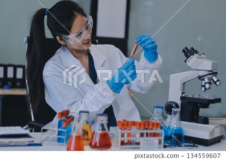 Portrait, science and happy woman on laptop in lab to research chemistry, test or innovation. Microscope, scientist and face of medical doctor in goggles for microbiology, healthcare or pharma study Portrait, science and happy woman on laptop in lab to research chemistry, test or innovation. Microscope, scientist and face of medical doctor in goggles for microbiology, healthcare or pharma study 134559607