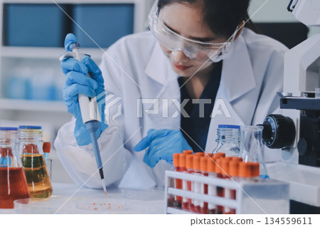 Portrait, science and happy woman on laptop in lab to research chemistry, test or innovation. Microscope, scientist and face of medical doctor in goggles for microbiology, healthcare or pharma study Portrait, science and happy woman on laptop in lab to research chemistry, test or innovation. Microscope, scientist and face of medical doctor in goggles for microbiology, healthcare or pharma study 134559611