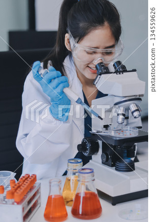 Portrait, science and happy woman on laptop in lab to research chemistry, test or innovation. Microscope, scientist and face of medical doctor in goggles for microbiology, healthcare or pharma study Portrait, science and happy woman on laptop in lab to research chemistry, test or innovation. Microscope, scientist and face of medical doctor in goggles for microbiology, healthcare or pharma study 134559626