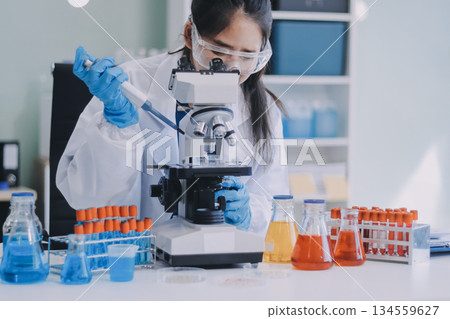 Portrait, science and happy woman on laptop in lab to research chemistry, test or innovation. Microscope, scientist and face of medical doctor in goggles for microbiology, healthcare or pharma study Portrait, science and happy woman on laptop in lab to research chemistry, test or innovation. Microscope, scientist and face of medical doctor in goggles for microbiology, healthcare or pharma study 134559627
