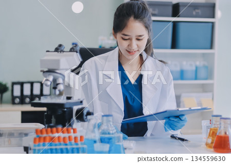 Portrait, science and happy woman on laptop in lab to research chemistry, test or innovation. Microscope, scientist and face of medical doctor in goggles for microbiology, healthcare or pharma study Portrait, science and happy woman on laptop in lab to research chemistry, test or innovation. Microscope, scientist and face of medical doctor in goggles for microbiology, healthcare or pharma study 134559630