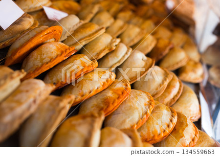 freshly baked empanadas with different fillings for sale 134559663