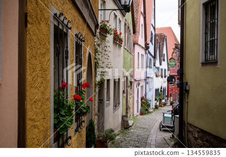 Charming medieval alley with colorful houses in Rothenburg ob der Tauber old town Charming medieval alley with colorful houses in Rothenburg ob der Tauber old town 134559835