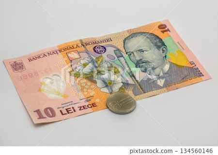 Romanian ten lei banknote with coin closeup on white background 134560146