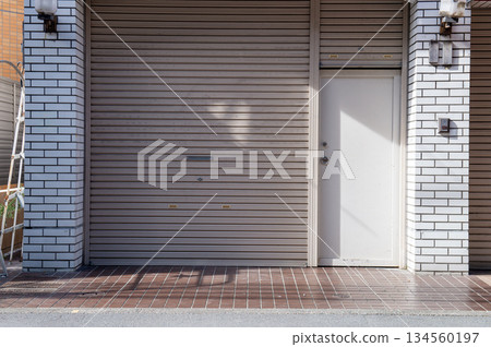 A closeup shot of automatic metal roller door used in factory, storage, garage, and industrial warehouse. The corrugated and foldable metal sheet offer space saving and provide urban and rustic feel 134560197
