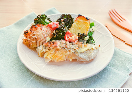 Baked cod and vegetables with mayonnaise and cheese Baked cod and vegetables with mayonnaise and cheese 134561160