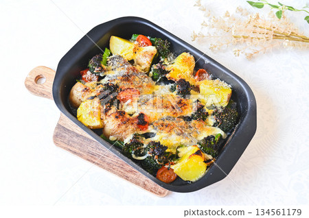 Baked cod and vegetables with mayonnaise and cheese Baked cod and vegetables with mayonnaise and cheese 134561179