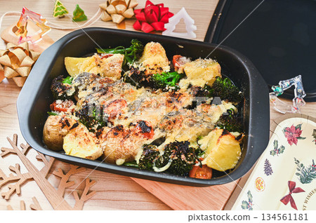 Baked cod and vegetables with mayonnaise and cheese 134561181