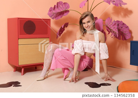 Smile and leisure captured in retro styled setting with pink plants Smile and leisure captured in retro styled setting with pink plants 134562358